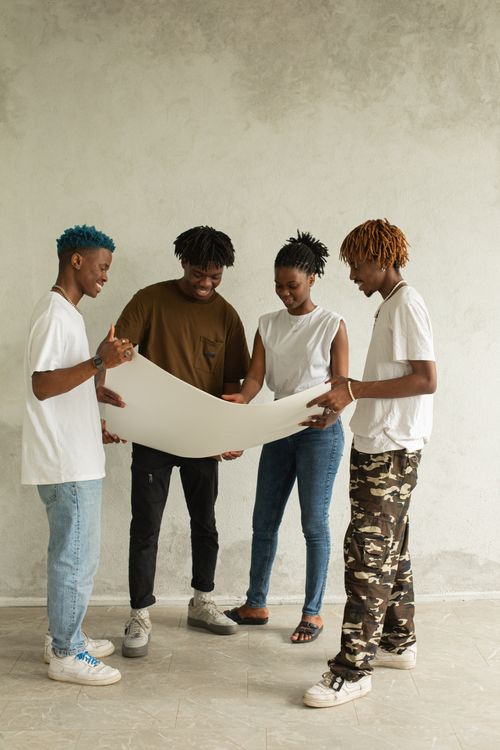 Stock photo of young adults collaborating on a community project